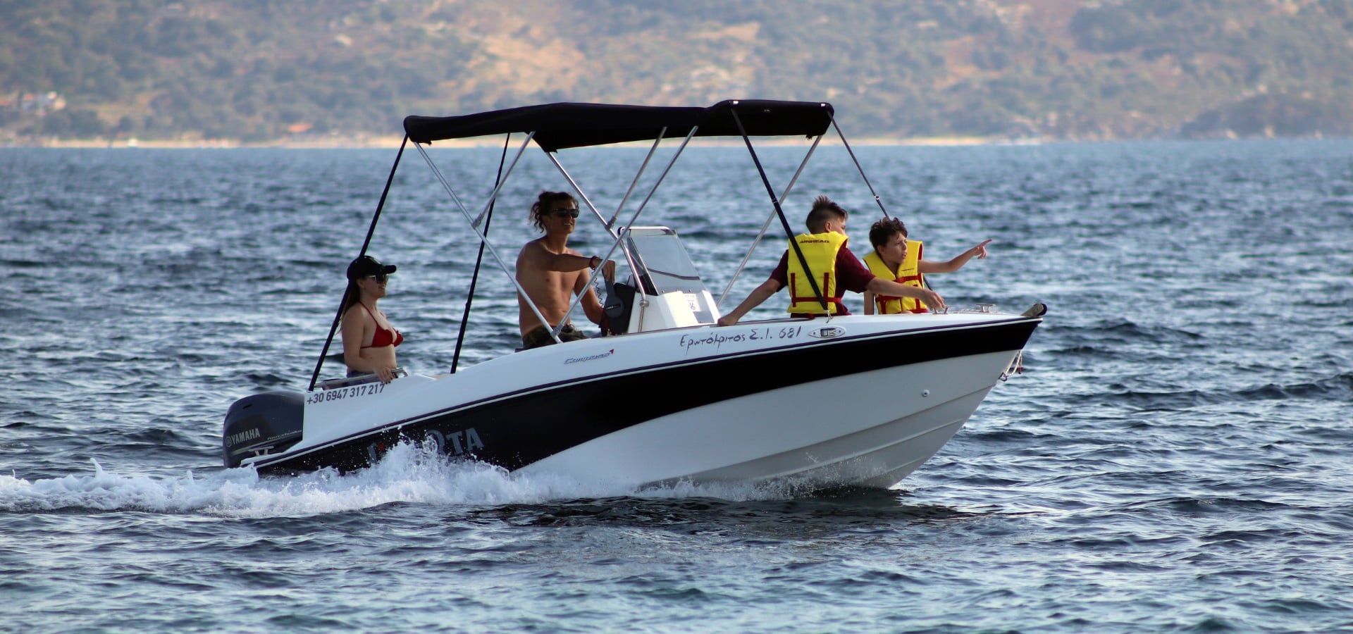 Boat floating on the sea near Ammouliani, Chalkidiki, available for rent from Liberta Boats